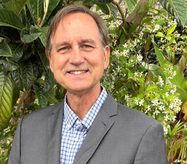 Bruce Scholten, CTO at Moleaer and Writer on Systems, Water, and Technology Portrait of Bruce Scholten, CTO at Moleaer, standing outdoors in a gray jacket surrounded by green foliage